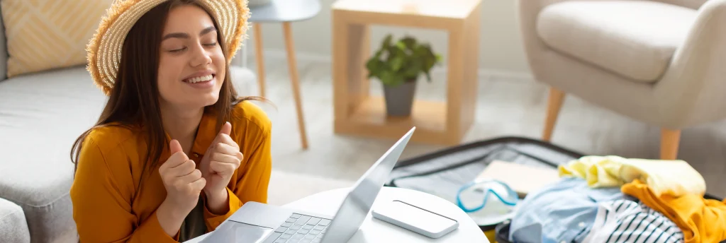 Woman planning travel with laptop using TripAdvisor data scraping for destination research and trip preparation